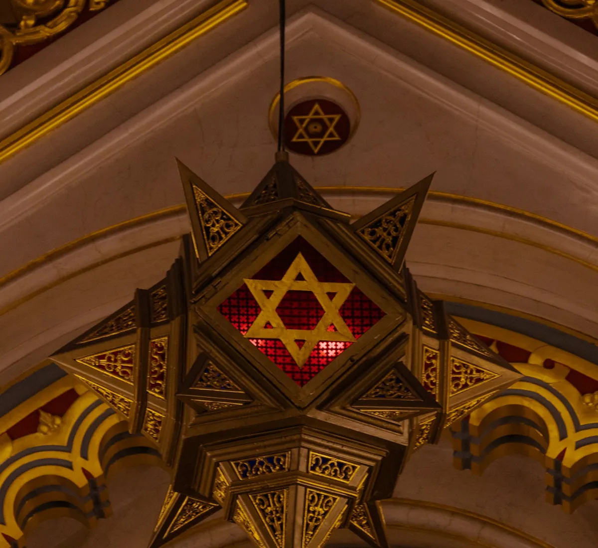 Star of David lantern hanging in an ornate synagogue